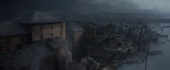 Movie still from “Enola Holmes 2” (2022), directed by Harry Bradbeer – An aerial view of an old town with a dark sky; Extreme Wide shot, High angle