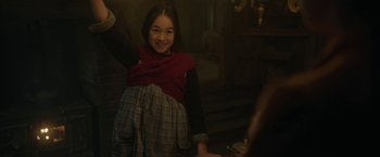 Movie still from “Enola Holmes 2” (2022), directed by Harry Bradbeer – A young girl in a red scarf is smiling; Medium shot, Low angle