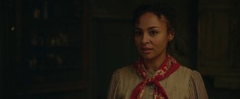Movie still from “Enola Holmes 2” (2022), directed by Harry Bradbeer – A woman wearing a red and white neck scarf; Close Up shot, Over the shoulder angle