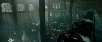 Movie still from “Enola Holmes 2” (2022), directed by Harry Bradbeer – A group of people sitting around a room; Extreme Wide shot, High angle