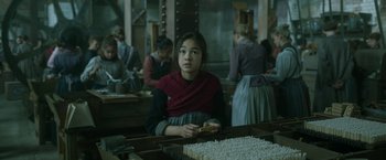 Movie still from “Enola Holmes 2” (2022), directed by Harry Bradbeer – A girl sitting at a table in front of a group of people; Medium shot, High angle