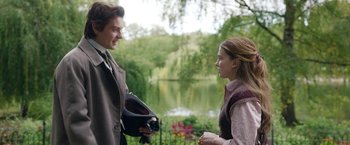 Movie still from “Enola Holmes 2” (2022), directed by Harry Bradbeer – A man and a woman talking in front of a body of water; Medium shot, Over the shoulder angle