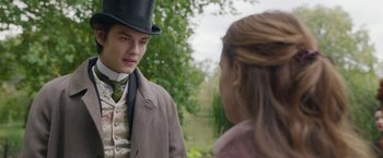 Movie still from “Enola Holmes 2” (2022), directed by Harry Bradbeer – A man in a top hat and a woman in a suit; Close Up shot, Over the shoulder angle