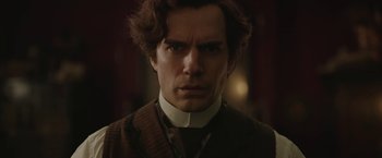 Movie still from “Enola Holmes 2” (2022), directed by Harry Bradbeer – A person wearing a suit and tie; Close Up shot, Over the shoulder angle