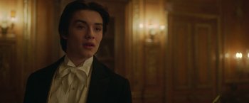 Movie still from “Enola Holmes 2” (2022), directed by Harry Bradbeer – A man in a suit and tie in front of a mirror; Close Up shot, Over the shoulder angle