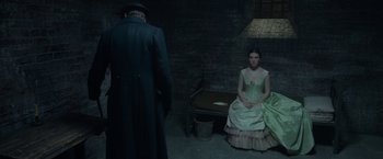 Movie still from “Enola Holmes 2” (2022), directed by Harry Bradbeer – A woman sitting on the ground next to a man; Wide shot, High angle