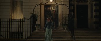 Movie still from “Enola Holmes 2” (2022), directed by Harry Bradbeer – A man and a woman walking down the steps of a house; Wide shot, Low angle
