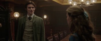 Movie still from “Enola Holmes 2” (2022), directed by Harry Bradbeer – A man and a woman are standing in front of each other; Medium shot, Over the shoulder angle