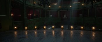 Movie still from “Enola Holmes 2” (2022), directed by Harry Bradbeer – Candles are lit on the floor of a dark room; Extreme Wide shot, High angle