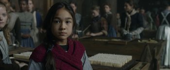 Movie still from “Enola Holmes 2” (2022), directed by Harry Bradbeer – A young girl wearing a red sweater and a red scarf; Close Up shot, Over the shoulder angle