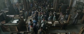 Movie still from “Enola Holmes 2” (2022), directed by Harry Bradbeer – An overhead view of a group of people standing in a room; Wide shot, High angle