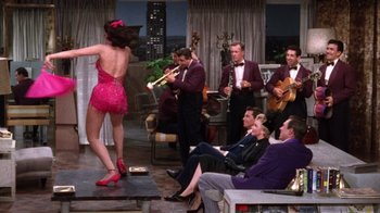 Movie still from “Kiss Me Kate” (1953), directed by George Sidney – A group of men and a woman performing on a stage; Wide shot, High angle