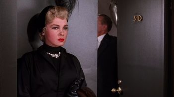 Movie still from “Kiss Me Kate” (1953), directed by George Sidney – A woman in a black dress and a man in a suit; Close Up shot, Low angle