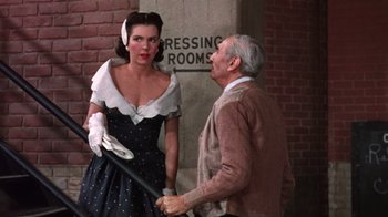 Movie still from “Kiss Me Kate” (1953), directed by George Sidney – An old man and a woman standing next to each other; Medium shot, Over the shoulder angle