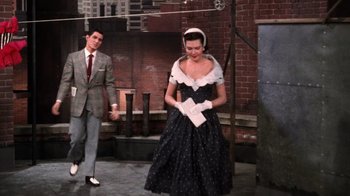 Movie still from “Kiss Me Kate” (1953), directed by George Sidney – A man and a woman dressed in a black dress; Wide shot, High angle