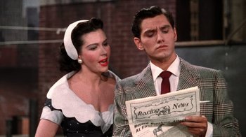 Movie still from “Kiss Me Kate” (1953), directed by George Sidney – A man and a woman are looking at a news paper; Close Up shot, Over the shoulder angle