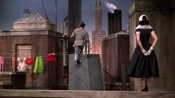 Movie still from “Kiss Me Kate” (1953), directed by George Sidney – A man riding a skateboard down the side of a ramp; Wide shot, Low angle