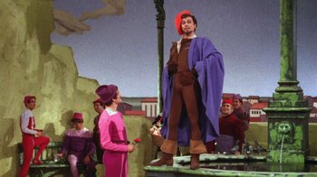 Movie still from “Kiss Me Kate” (1953), directed by George Sidney – A man and a woman are dressed in medieval garb; Wide shot, Low angle