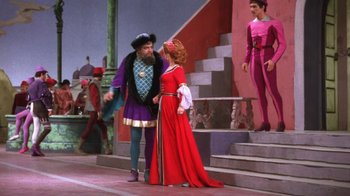 Movie still from “Kiss Me Kate” (1953), directed by George Sidney – A man and a woman dressed in medieval clothing; Wide shot, Low angle