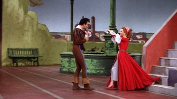 Movie still from “Kiss Me Kate” (1953), directed by George Sidney – A man and a woman dressed in medieval garb; Wide shot, Low angle