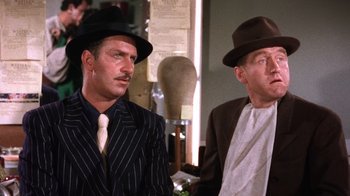 Movie still from “Kiss Me Kate” (1953), directed by George Sidney – A couple of men wearing hats and suits; Close Up shot, Low angle