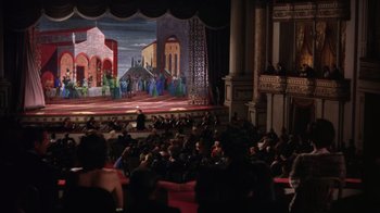 Movie still from “Kiss Me Kate” (1953), directed by George Sidney – People are sitting in front of a large stage; Extreme Wide shot, High angle
