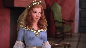 Movie still from “Kiss Me Kate” (1953), directed by George Sidney – A woman with red hair wearing a blue dress and a veil; Medium shot, Over the shoulder angle