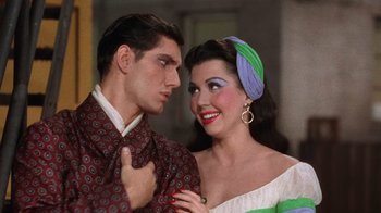 Movie still from “Kiss Me Kate” (1953), directed by George Sidney – A man and a woman standing next to each other; Close Up shot, High angle