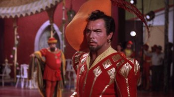 Movie still from “Kiss Me Kate” (1953), directed by George Sidney – A person wearing a suit and a hat; Medium shot, Over the shoulder angle