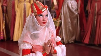 Movie still from “Kiss Me Kate” (1953), directed by George Sidney – A woman dressed as a nun with her hands folded in front of her face; Close Up shot, Low angle