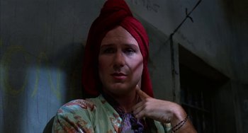 Movie still from “Kiss of the Spider Woman” (1985), directed by Hector Babenco – A man with a red turban on his head; Close Up shot, Low angle