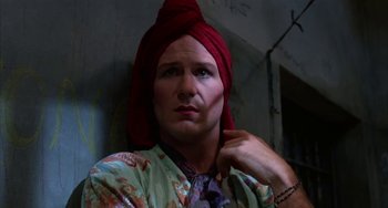 Movie still from “Kiss of the Spider Woman” (1985), directed by Hector Babenco – A man with a red turban on his head; Close Up shot, Low angle