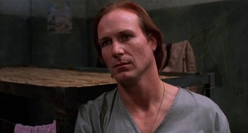 Movie still from “Kiss of the Spider Woman” (1985), directed by Hector Babenco – A person with long red hair; Close Up shot, Low angle