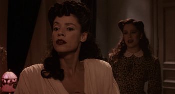 Movie still from “Kiss of the Spider Woman” (1985), directed by Hector Babenco – A woman with long black hair wearing a white dress; Close Up shot, Low angle