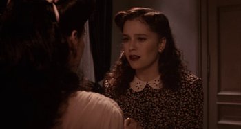 Movie still from “Kiss of the Spider Woman” (1985), directed by Hector Babenco – A woman in a black and white dress talking to another woman in front of a mirror; Close Up shot, Over the shoulder angle