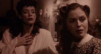 Movie still from “Kiss of the Spider Woman” (1985), directed by Hector Babenco – Two women are standing in front of a mirror; Close Up shot, Over the shoulder angle