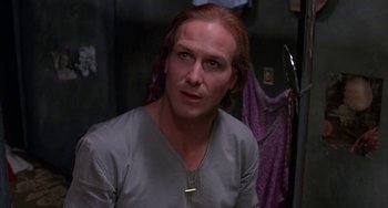 Movie still from “Kiss of the Spider Woman” (1985), directed by Hector Babenco – A person with long red hair; Close Up shot, Over the shoulder angle