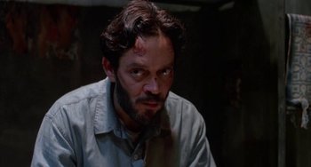 Movie still from “Kiss of the Spider Woman” (1985), directed by Hector Babenco – A person with a beard; Close Up shot, High angle