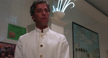 Movie still from “Kiss of the Spider Woman” (1985), directed by Hector Babenco – A man in a white suit standing in front of a mirror; Close Up shot, Low angle