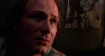 Movie still from “Kiss of the Spider Woman” (1985), directed by Hector Babenco – A person with tears in their eyes; Close Up shot, Low angle