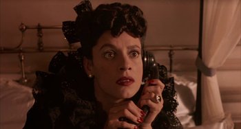 Movie still from “Kiss of the Spider Woman” (1985), directed by Hector Babenco – A woman in a black dress talking on a phone; Close Up shot, High angle
