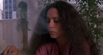 Movie still from “Kiss of the Spider Woman” (1985), directed by Hector Babenco – A woman with long black hair sitting in a room; Close Up shot, Low angle