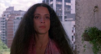 Movie still from “Kiss of the Spider Woman” (1985), directed by Hector Babenco – A person with long black hair; Close Up shot, Low angle