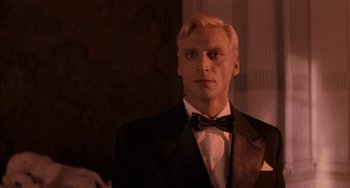 Movie still from “Kiss of the Spider Woman” (1985), directed by Hector Babenco – A person wearing a suit and bow tie; Close Up shot, Low angle