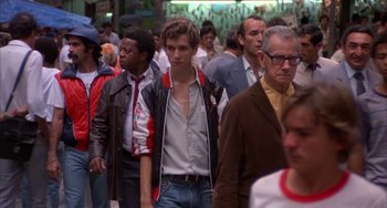 Movie still from “Kiss of the Spider Woman” (1985), directed by Hector Babenco – A crowd of people walking down a street; Wide shot, Low angle