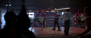 Movie still from “Kiss the Girls” (1997), directed by Gary Fleder – Two men are boxing in a boxing ring; Wide shot, High angle
