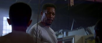 Movie still from “Kiss the Girls” (1997), directed by Gary Fleder – An older man is standing in front of a mirror; Close Up shot, Over the shoulder angle