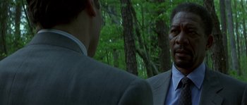 Movie still from “Kiss the Girls” (1997), directed by Gary Fleder – Two men are talking in a wooded area; Close Up shot, Over the shoulder angle