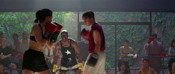 Movie still from “Kiss the Girls” (1997), directed by Gary Fleder – A group of boxers in a boxing ring with spectators watching; Medium shot, Over the shoulder angle