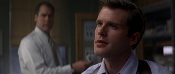 Movie still from “Kiss the Girls” (1997), directed by Gary Fleder – A person wearing a shirt and tie; Close Up shot, Over the shoulder angle